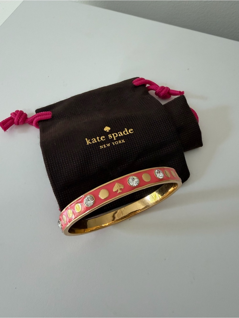 kate spade spotlight bangle with coral pink enamel and crystal accents